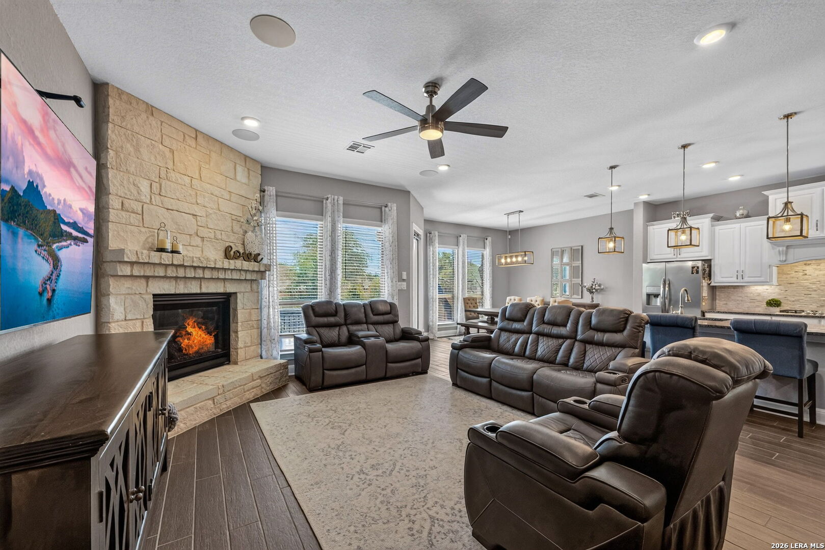 8218 Claret Cup Way Boerne TX open concept living room fireplace high ceilings island kitchen Fallbrook Emerald Homes interior