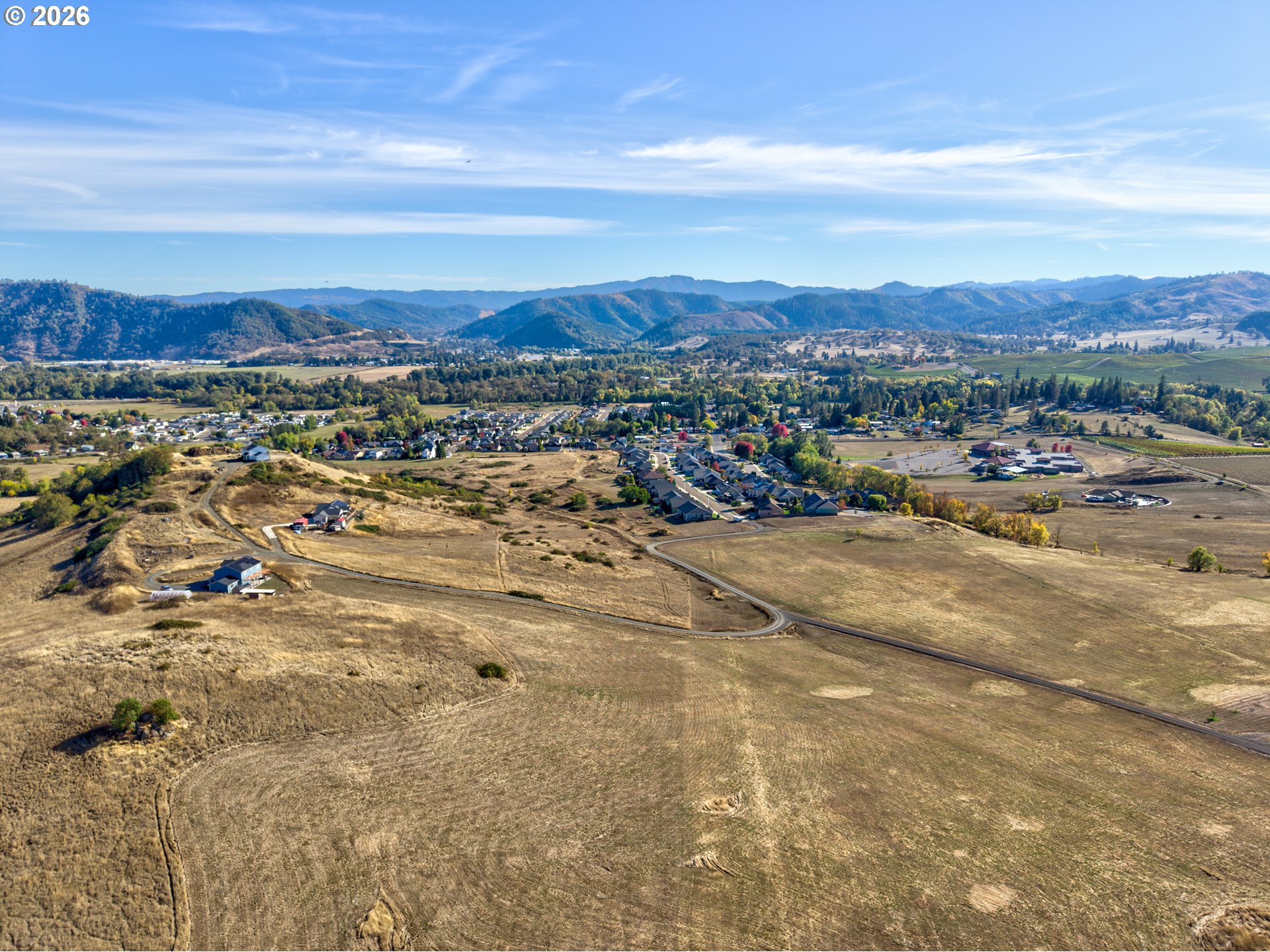 Aerial view of open land and surrounding homes near Wil Way in Winston