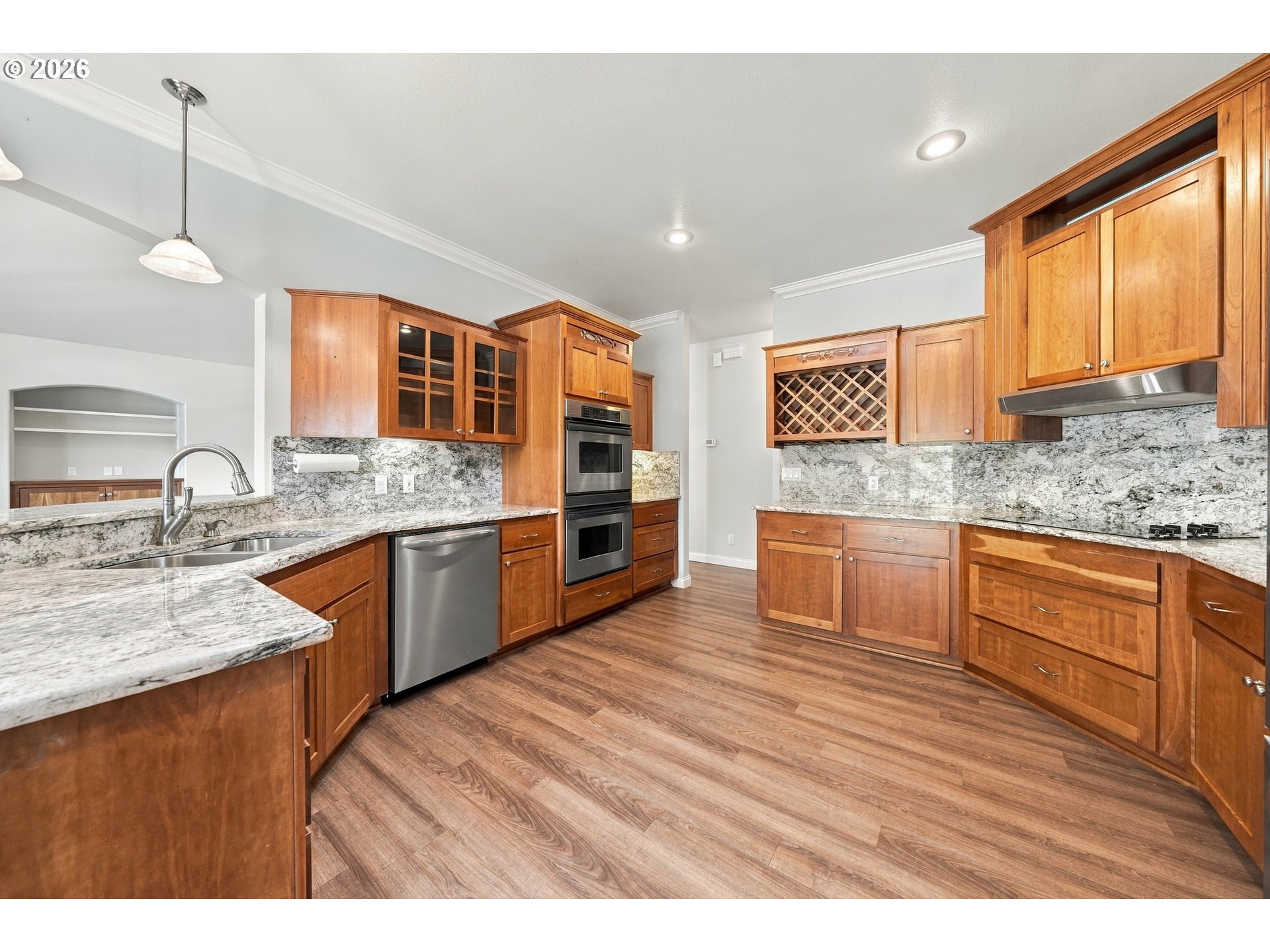 Kitchen with granite countertops, wood cabinets and double ovens at 711 Sable Dr