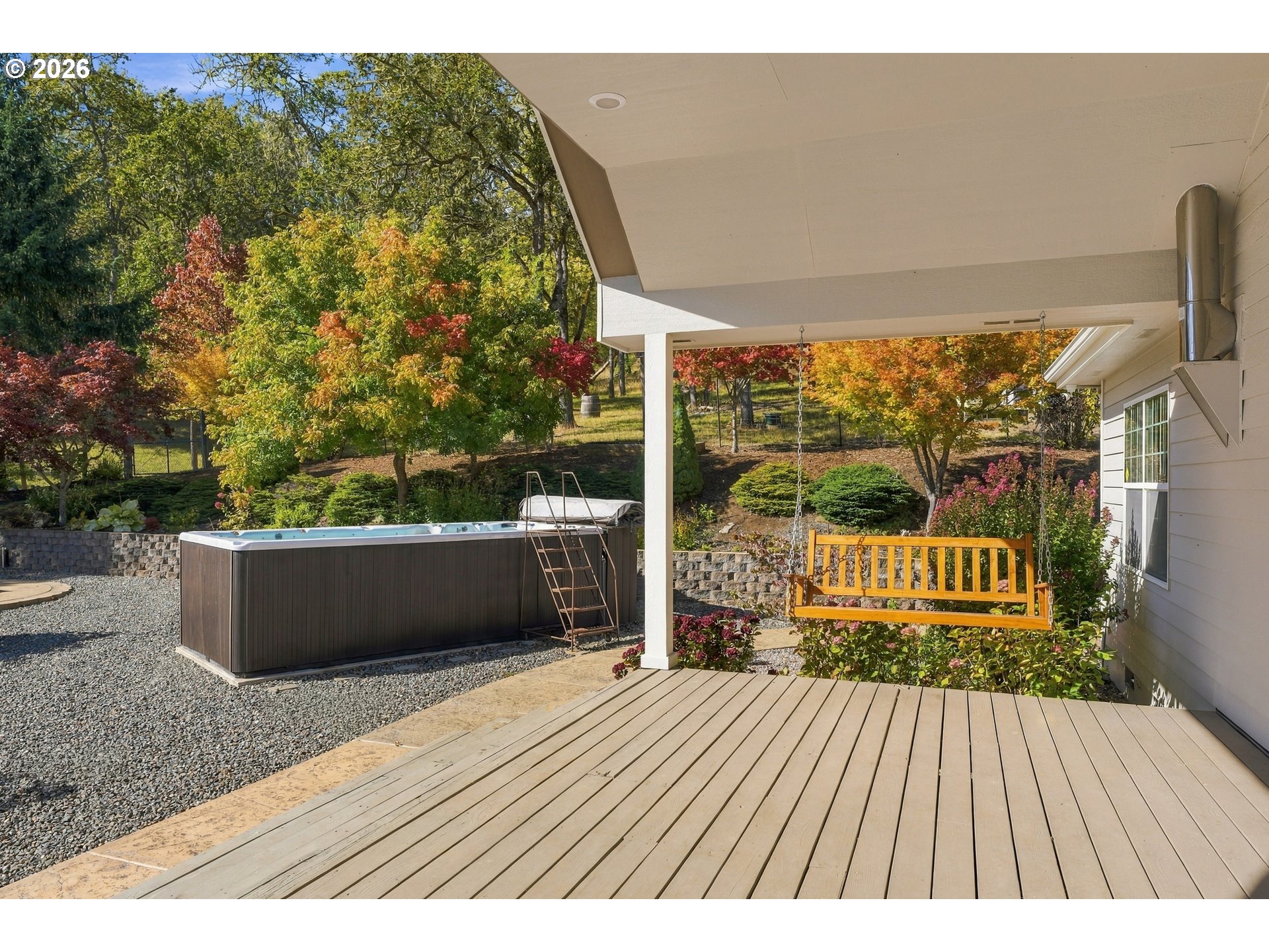 Covered back patio with porch swing and swim spa at 711 Sable Dr