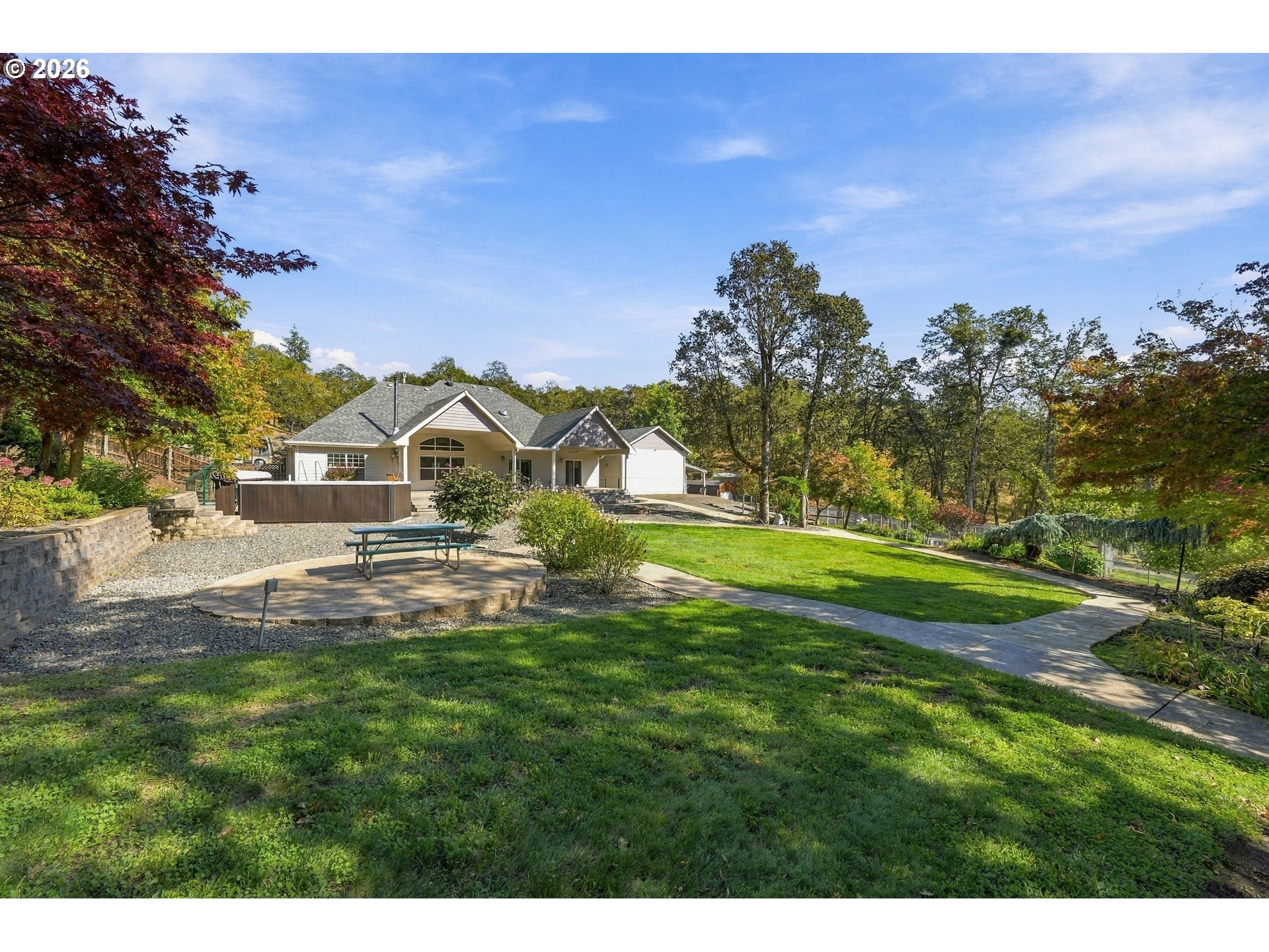 Landscaped lawn and stamped concrete pathway behind 711 Sable Dr