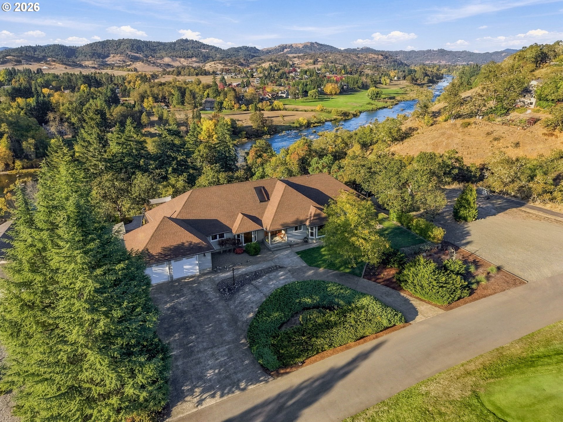 Aerial view of 365 Birdie Ln with the North Umpqua River and golf course beyond