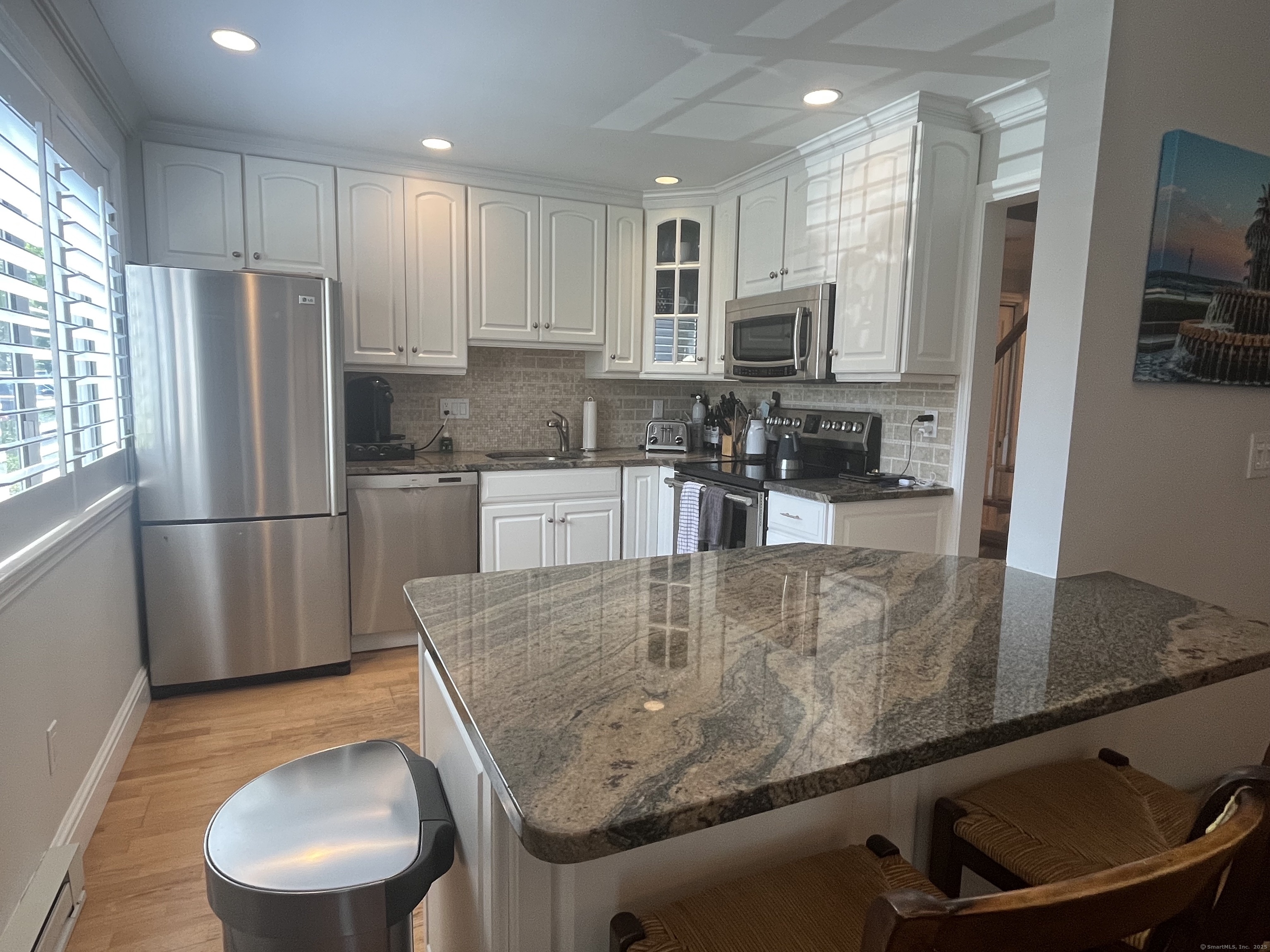 Kitchen with granite countertops and white cabinets