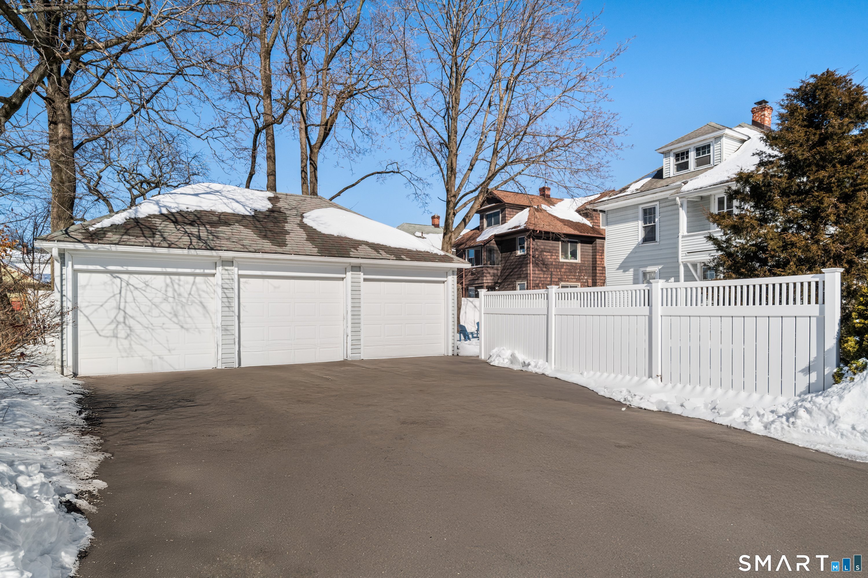 Three-car detached garage with paved driveway